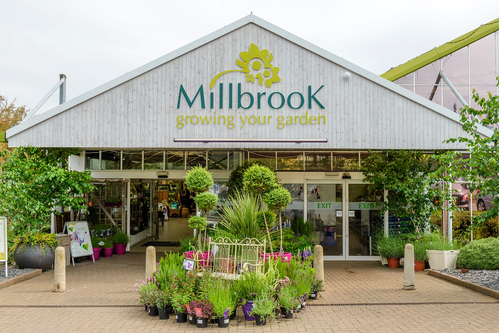 Entrance to Millbrook Garden Company showcasing various plants.