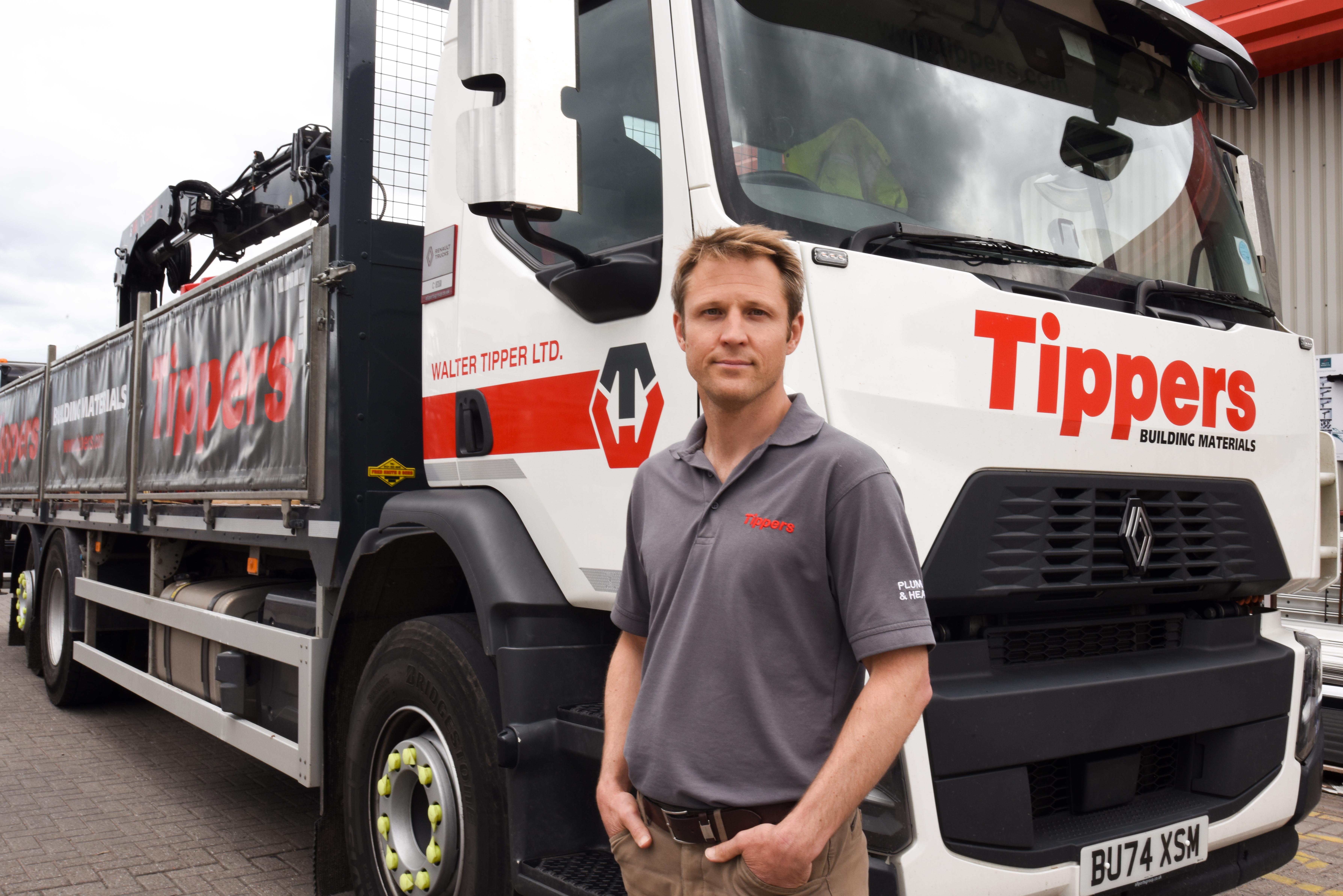 Joe Tipper, Director of Tippers, in front of a Tippers Building Materials truck.