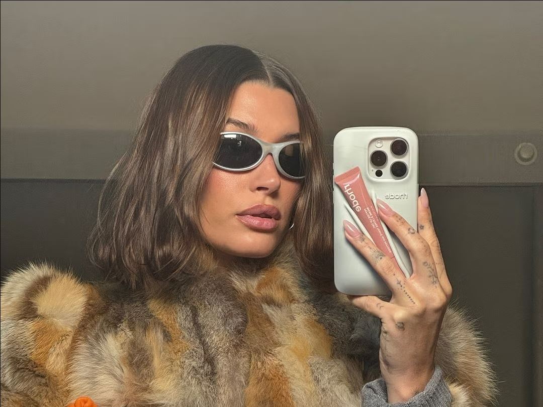 Hailey Bieber with Rhode lip gloss.